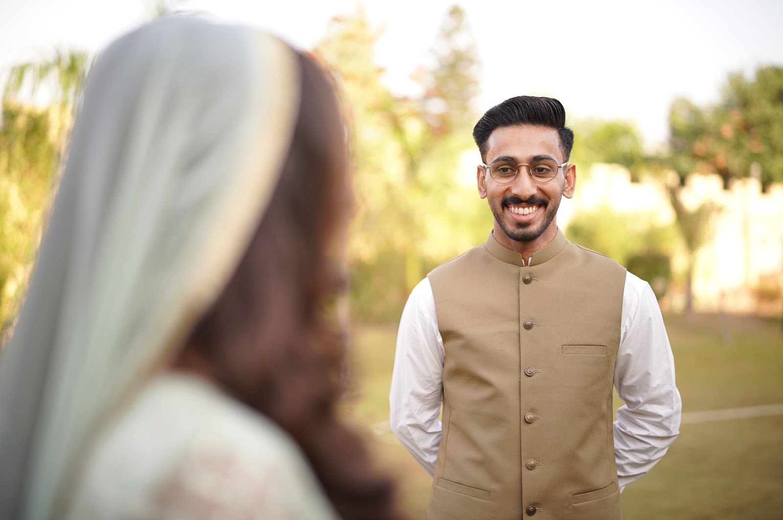 Groom smiling at his bride